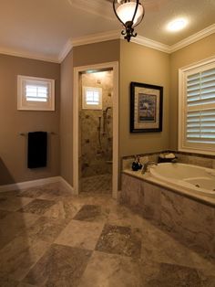 a bathroom with a walk in shower next to a bath tub