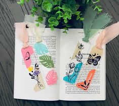 an open book with some flowers on it