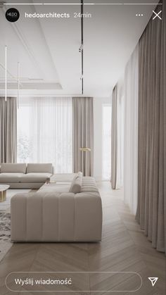 a living room with white couches and beige curtains