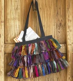 a multicolored purse hanging on a wooden door