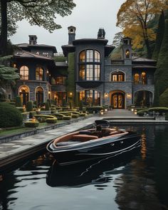 a boat is parked in front of a large house