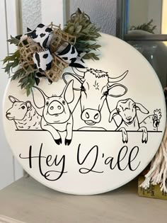 a sign that says hey sale with cows and cow heads on the front of it