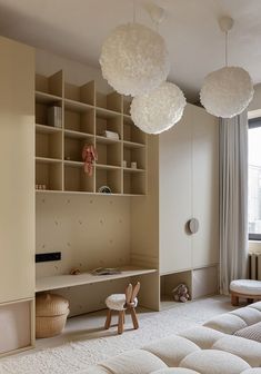 a child's bedroom with white furniture and hanging lights