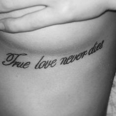 a woman's stomach with the words true love never dies on it