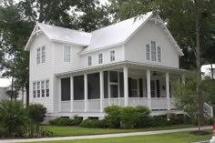 a large white house sitting on the side of a road