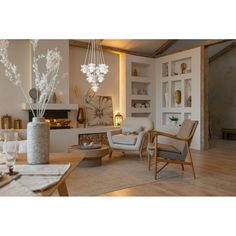 a living room filled with furniture and a chandelier