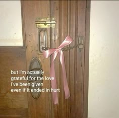 a door with a pink ribbon tied to it and a quote written on the front