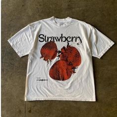 Strawberry Graphic Tee - Fresh Fruit-Inspired Casual Fashion Add a pop of freshness to your wardrobe with this bold tee featuring vibrant strawberry graphics and elegant "Strawberry" text. Perfect for fruit lovers and those who enjoy unique, food-inspired fashion. 👕 Material: 100% Cotton 🎨 Design: Bold Strawberry Graphic with Stylish "Strawberry" Text 📏 Sizes: M-3XL ⏳ Custom Creation Time: Please allow 1-2 weeks for production. #StrawberryTee #FruitInspiredFashion #GraphicTshirt #CasualWear # White T-shirt With Fruit Design For Spring, White Relaxed Fit T-shirt With Strawberry Print, Relaxed Fit T-shirt With Fruit Print For Spring, Trendy Red T-shirt With Strawberry Print, Retro Spring Tops With Strawberry Print, Retro Spring Top With Strawberry Print, Vintage Fruit Print Top For Summer, Vintage Summer Top With Fruit Print, Casual White Tops With Fruit Design