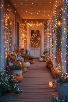 a porch decorated for halloween with pumpkins and lights