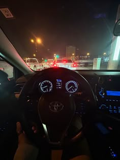 the interior of a car with dashboard lights and gauges on it at night time