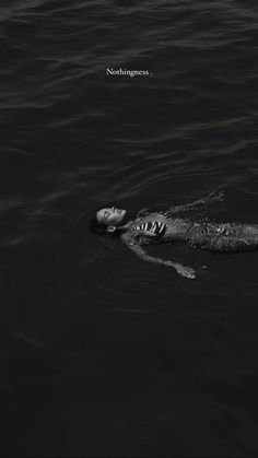 a person floating in the water with their head above the water's surface, and an ad that reads seahorses