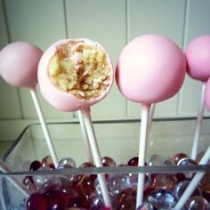 some cake pops are in a glass container