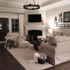 a living room filled with furniture and a fire place in the middle of a room