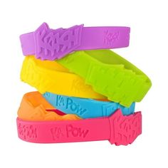 four different colored bracelets with the word wow written on each wristband, all in various colors