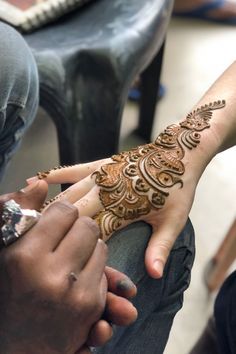 two people with henna tattoos on their hands