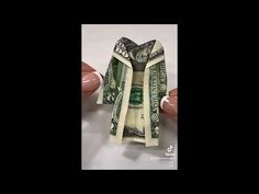 a dollar bill wrapped in white paper sitting on top of a table