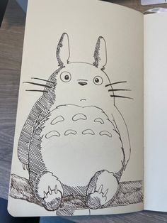 a drawing of a totoro sitting on top of a table