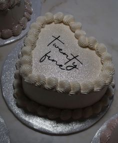 a heart shaped cake with the words thank you written on it in cursive writing