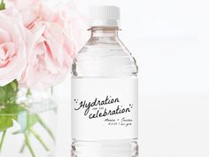 a bottle of water next to a vase with flowers in it and the label says, hydration for celebration