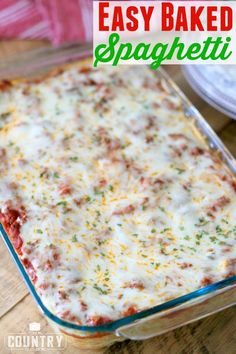 an easy baked spaghetti casserole recipe in a glass dish on a wooden table