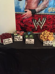 the table is set up with food and decorations for an wwe birthday party or event