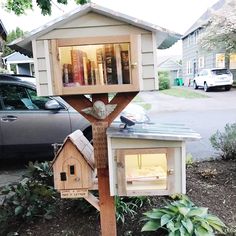 a bird house with books on the roof