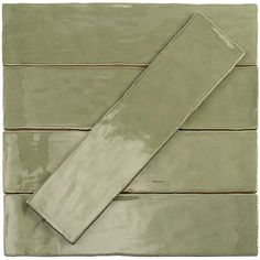 a green tile with brown lines on the bottom and one white line on the top