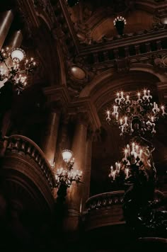 the chandeliers are hanging from the ceiling in the building's ornately decorated interior