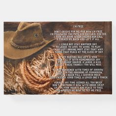 a cowboy's hat and rope with the poem written in white ink on wood