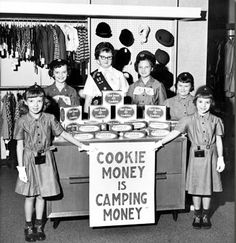 a group of children standing in front of a sign that says cookie money is camping money