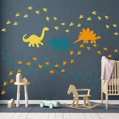 a child's room with dinosaur wall decals and rocking chair in the foreground