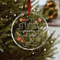 a glass ornament hanging from a christmas tree