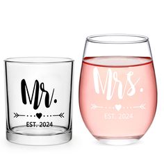 two personalized wine glasses sitting next to each other on a white surface with the words mr and mrs in cursive font