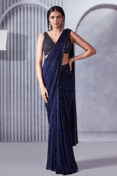 Midnight blue pre-draped saree with sequins, cutdana and beaded embroidery. Comes with a blouse. Components: 2 Pattern: Embroidered Type Of Work: Sequins, Cutdana, Beads Neckline: V Neck Sleeve Type: Sleeveless Fabric: Saree: Crepe chiffon, Blouse: Soft net, Lining: Shantoon Color: Blue Other Details:  Attached lining Length: Saree: 44 inches Blouse: 14 inches Closure: Saree: Side zip Blouse: Back hooks Occasion: Destination Wedding - Aza Fashions Western Sarees, Unique Saree Designs Party Wear, Sarees For Graduation Day, Dark Blue Saree For Farewell, Blue Sarees, Silver Saree, Farewell Sarees Colleges, Sleeveless Blouse Saree, Saree For Wedding Function