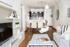 a living room filled with furniture and a flat screen tv