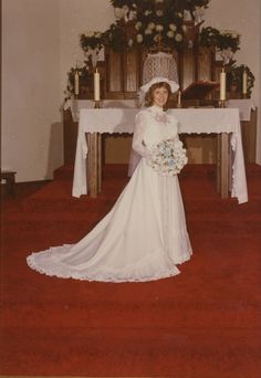 an old photo of a woman in a wedding dress