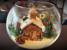 a glass bowl filled with snow and christmas decorations