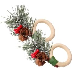 two wooden rings with pine cones and red berries