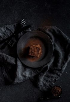 a plate with some food on top of it next to a fork and spoons