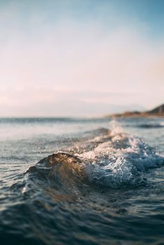 the water is splashing on top of the waves