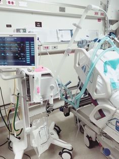 a hospital room with medical equipment and monitors on the wall, including an iv machine