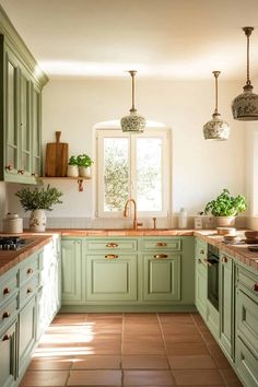 a kitchen filled with lots of green cabinets