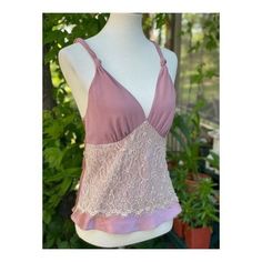 "Approx flat lay measurements Chest 16\" Length 23.5\" Size small on tag. 100% polyester. Made in China. Stunning satin camisole in a dusty rose colour way. A lace panel decorates across the abdomen, v neckline, straps feature a twisted knot design. No closures, it is pull on. No holes, tears or stains, pet snd smoke free home." Feminine Pink Lace Top Camisole, Pink Fitted Lace Top Camisole, Fitted Lace Top Pink Camisole, Fitted Pink Camisole With Lace Top, Pink Lace Top Camisole, Feminine Pink Tank Camisole, Pink Tank Camisole With Delicate Straps, Summer Bra Friendly Pink Camisole, Chic Pink Lace Trim Camisole