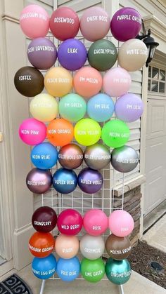 there are many different colored balloons on the rack