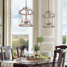 a dining room table with chairs and a chandelier hanging from it's ceiling