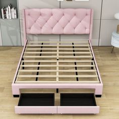 a bed with pink upholstered headboard and foot board is shown in an empty room