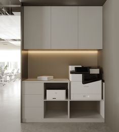 an office with white cabinets and drawers