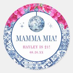 a round sticker with pink flowers on it and the words mamma mia written in blue