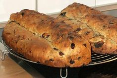 two loaves of bread sitting on top of an oven rack in the middle of a counter