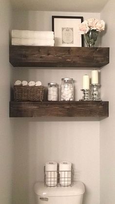 two shelves above a toilet in a bathroom